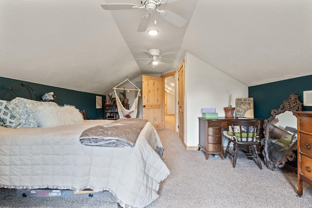 carpeted bedroom with lofted ceiling, ceiling fan, a textured ceiling, and baseboards