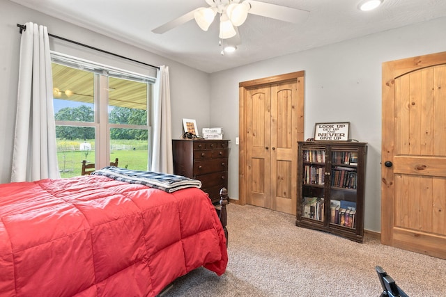 bedroom with carpet floors, ceiling fan, and baseboards