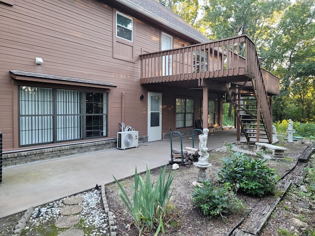 rear view of house featuring ac unit, roof with shingles, a patio, and stairway