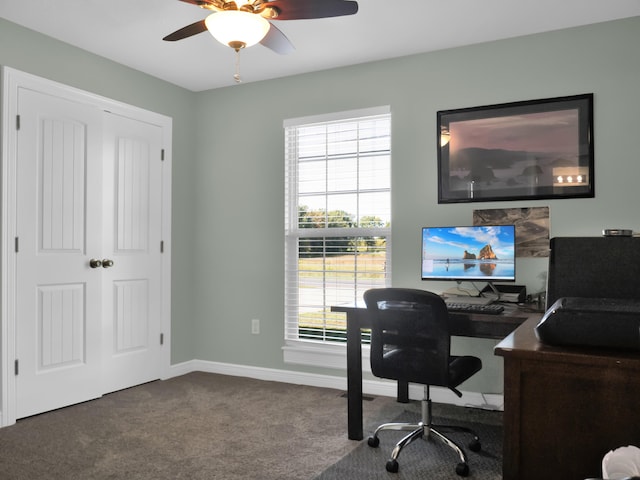 carpeted office with a ceiling fan and baseboards