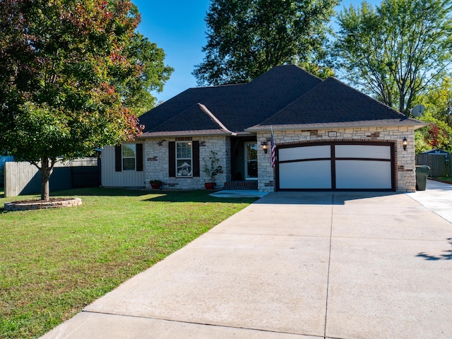 ranch-style home with a garage, a front yard, fence, and driveway