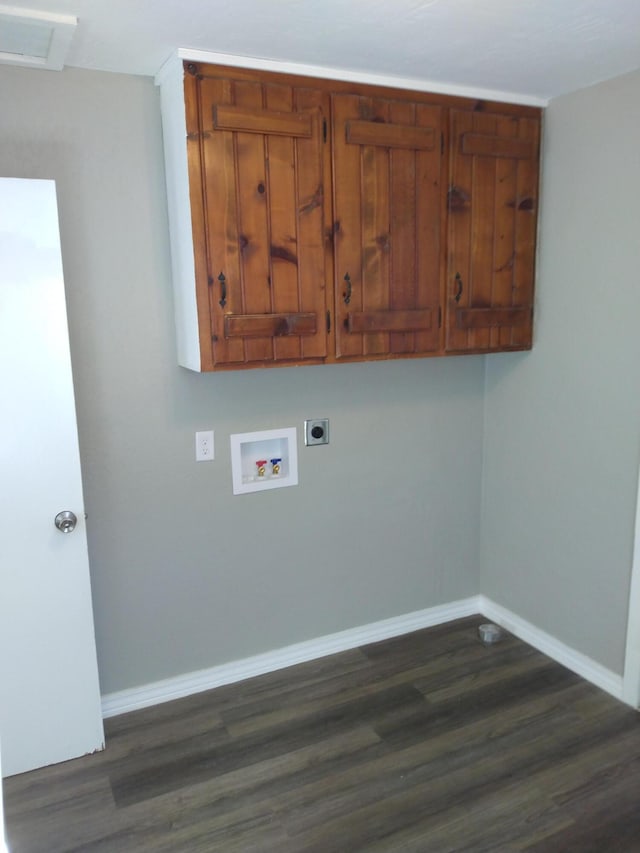 laundry room featuring dark wood-style floors, hookup for a washing machine, cabinet space, electric dryer hookup, and baseboards