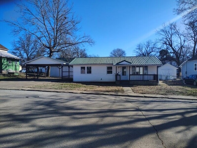 view of front facade with metal roof and a detached carport