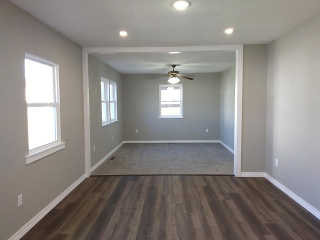 empty room featuring dark wood-type flooring, recessed lighting, ceiling fan, and baseboards