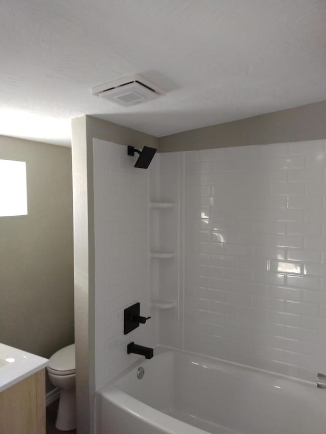 bathroom with toilet, visible vents,  shower combination, and vanity