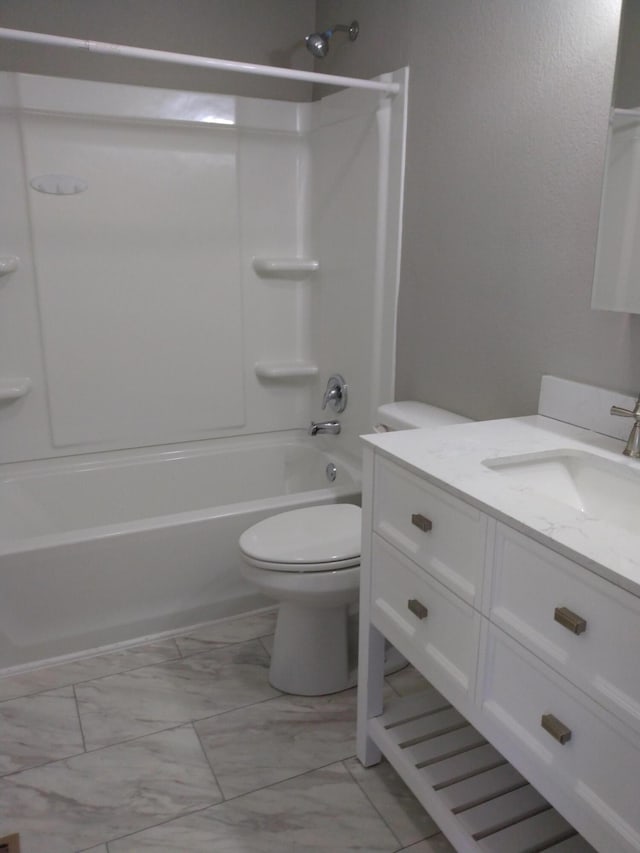 full bath featuring shower / washtub combination, marble finish floor, vanity, and toilet