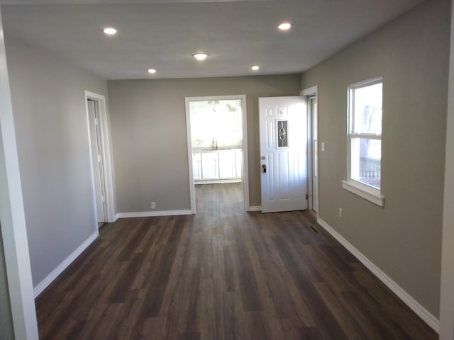 interior space featuring dark wood-style floors, visible vents, baseboards, and recessed lighting