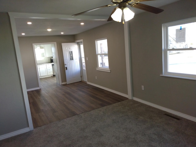 foyer entrance featuring ceiling fan, recessed lighting, dark wood-type flooring, baseboards, and dark colored carpet