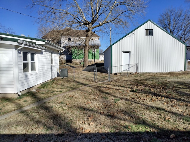 view of side of property with a gate, fence, and central AC unit