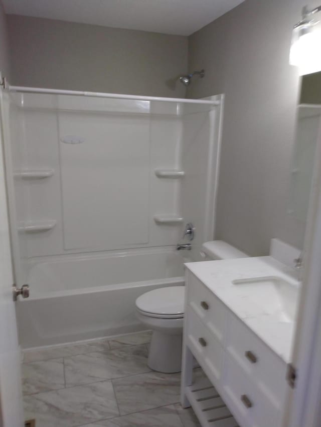 full bath featuring shower / bathtub combination, marble finish floor, vanity, and toilet