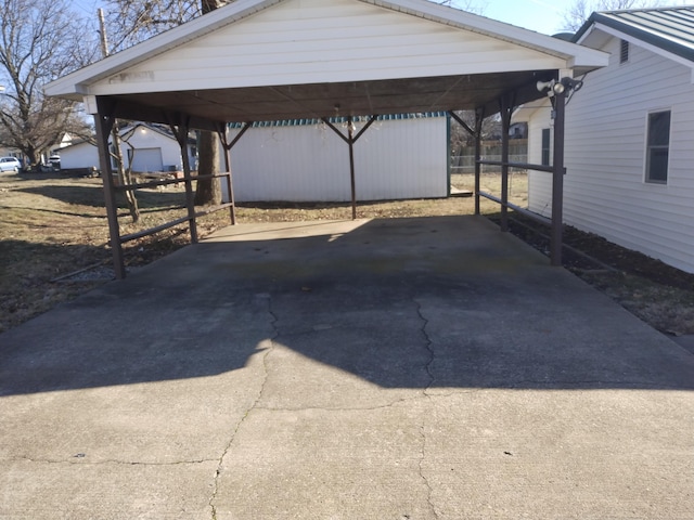 view of parking / parking lot featuring a detached carport and driveway