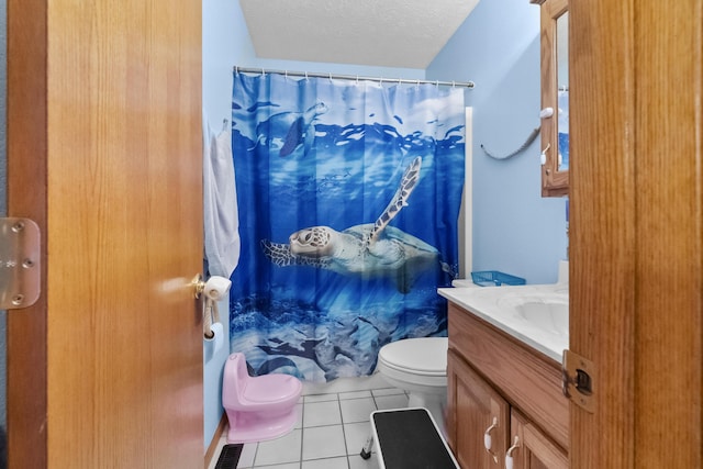 bathroom featuring a shower with shower curtain, toilet, a textured ceiling, vanity, and tile patterned flooring