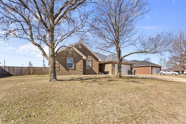 single story home featuring a garage, a front yard, brick siding, and fence