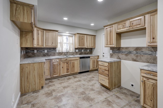 kitchen with light countertops, a sink, backsplash, and stainless steel dishwasher