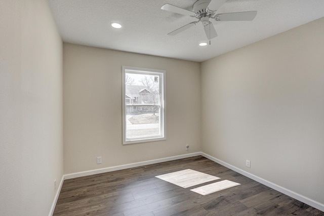 unfurnished room with baseboards, a ceiling fan, dark wood-style floors, a textured ceiling, and recessed lighting