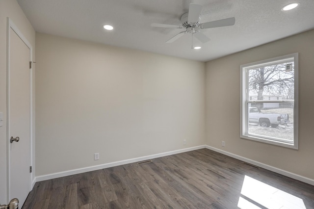 unfurnished room featuring baseboards, dark wood-style flooring, and recessed lighting