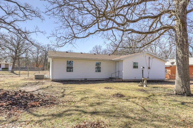 back of property featuring central air condition unit, crawl space, fence, and a lawn