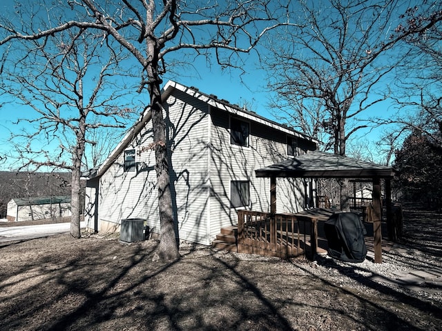 view of home's exterior with a wooden deck