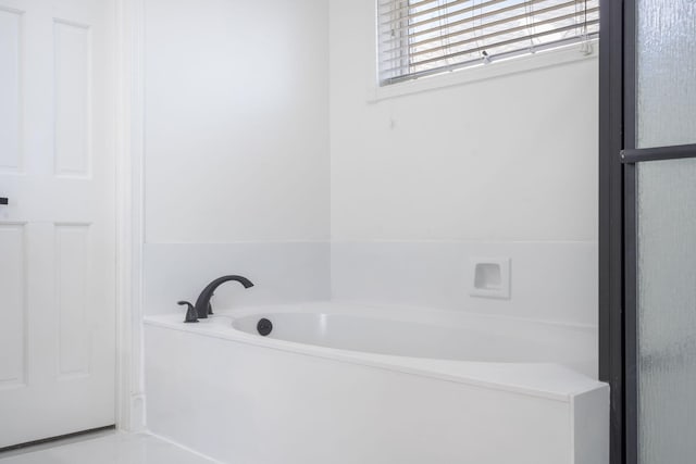 bathroom with a garden tub