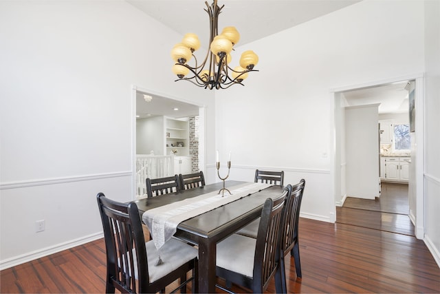 dining room with an inviting chandelier, built in shelves, baseboards, and dark wood-style flooring