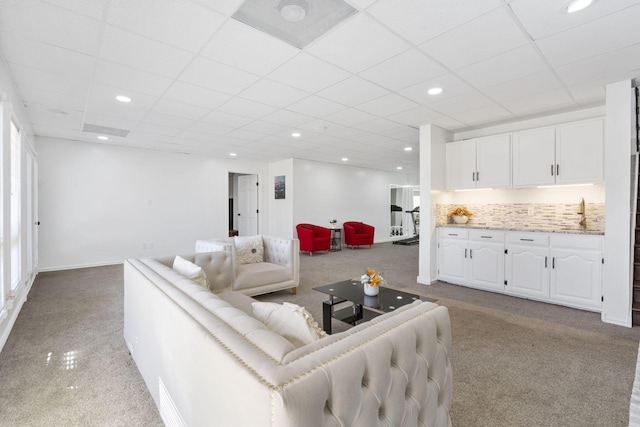 living room with recessed lighting, baseboards, a paneled ceiling, and carpet