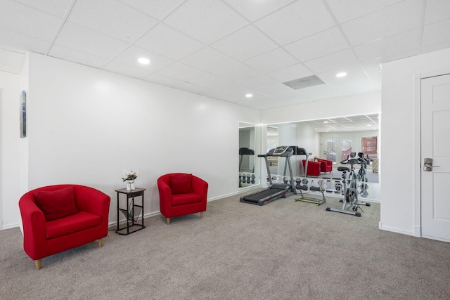 exercise room with a paneled ceiling, carpet, baseboards, and recessed lighting