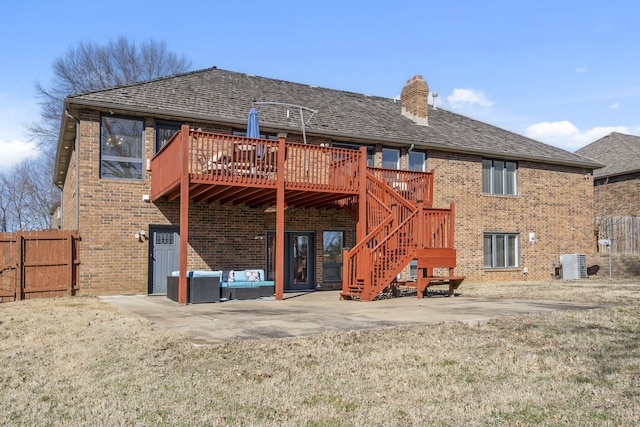 rear view of property with brick siding, fence, stairs, a chimney, and a patio area