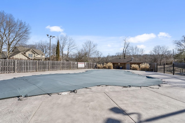 community pool featuring a patio and fence