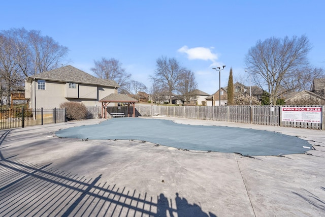 view of pool with fence and a patio