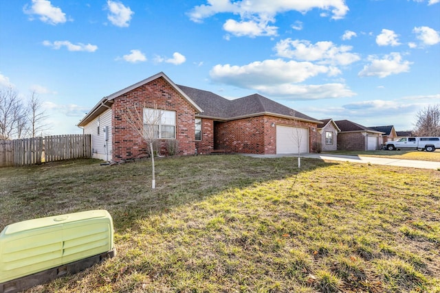 ranch-style home featuring driveway, an attached garage, fence, a front lawn, and brick siding