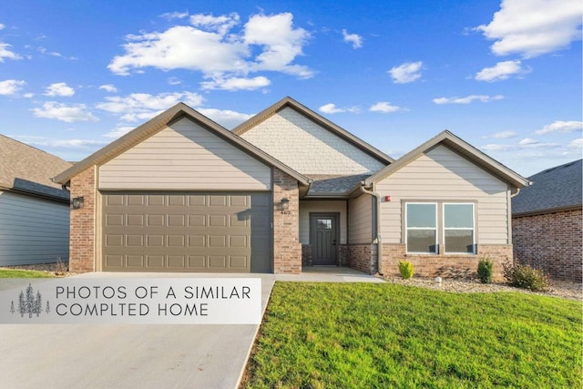 craftsman-style home with an attached garage, brick siding, concrete driveway, and a front yard