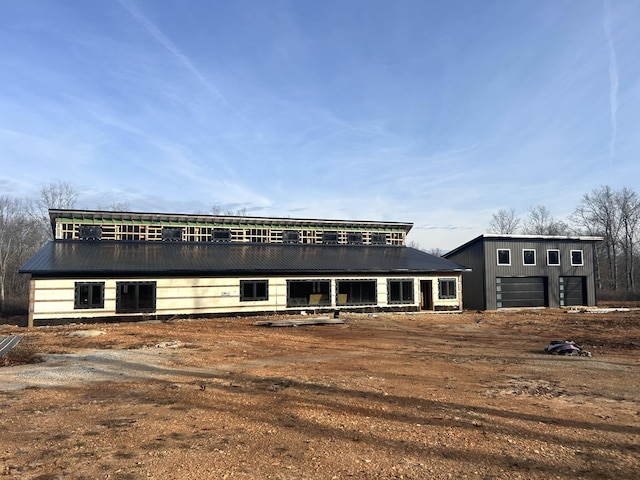 view of front facade with a garage and metal roof