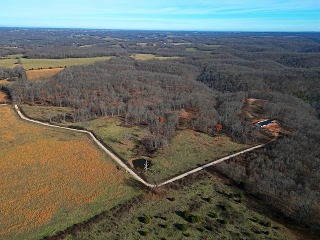 bird's eye view featuring a wooded view