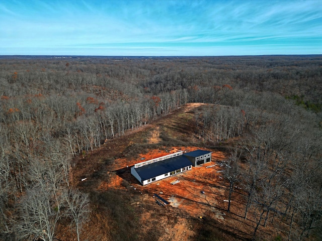 bird's eye view with a wooded view