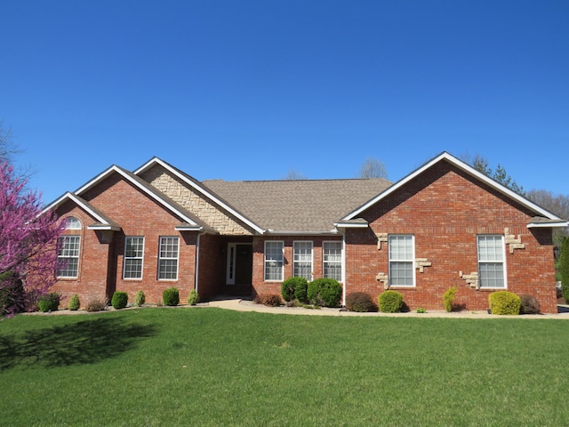 view of front of property with a front lawn and brick siding