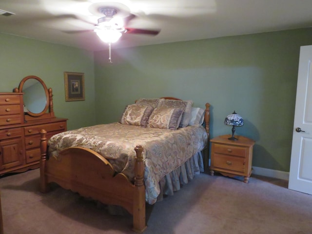 bedroom featuring a ceiling fan, light colored carpet, and baseboards