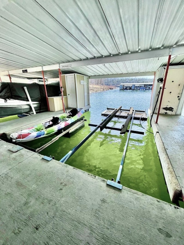 dock area with a water view and boat lift