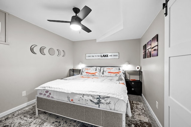 bedroom with ceiling fan and baseboards