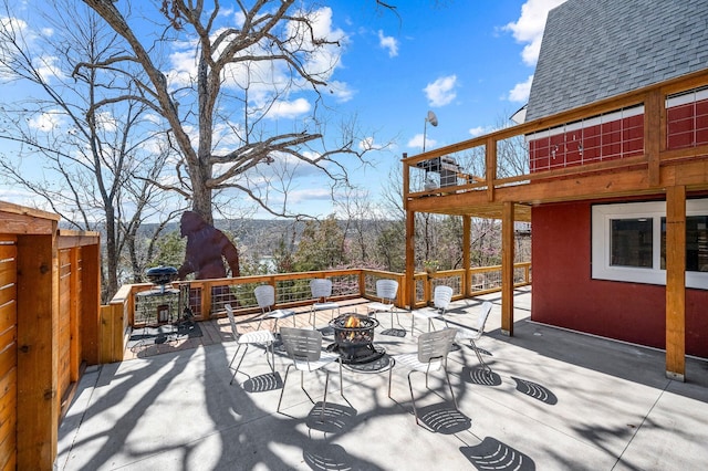 wooden terrace with an outdoor fire pit