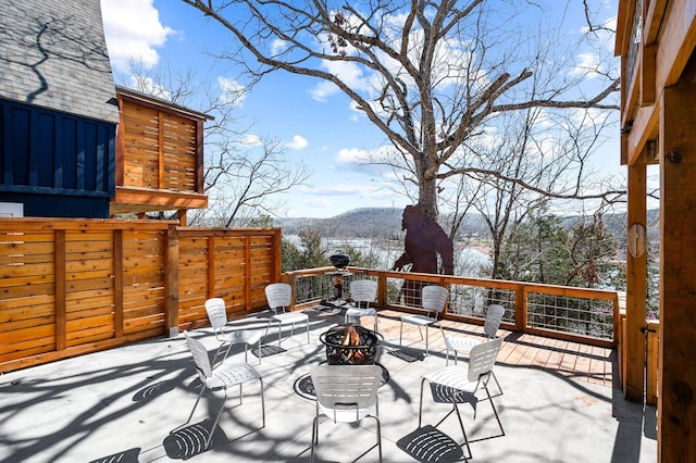 view of patio with a fire pit and a mountain view