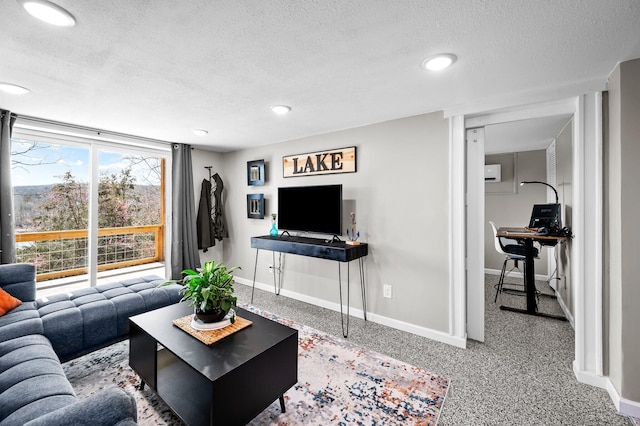 living room with a textured ceiling, recessed lighting, and baseboards