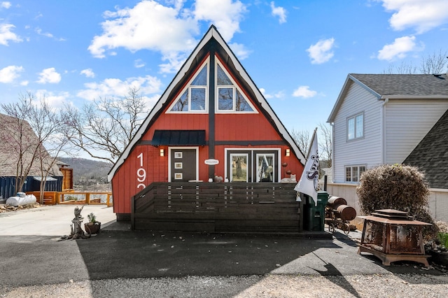 a-frame home with a fenced front yard