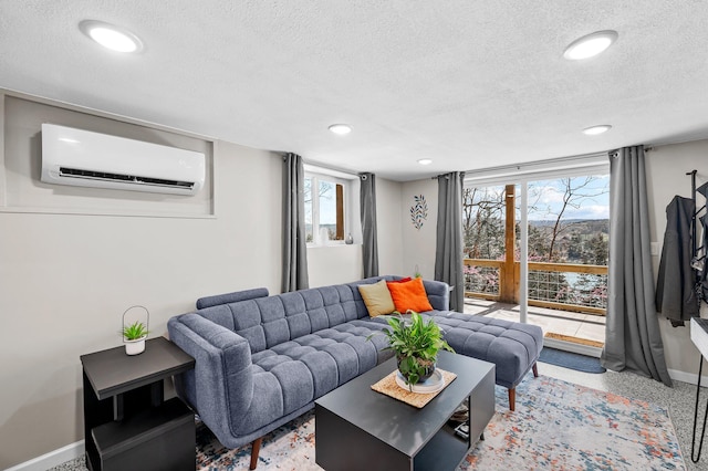 living room with an AC wall unit, recessed lighting, and baseboards