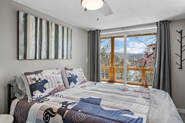 bedroom featuring a textured ceiling and a ceiling fan