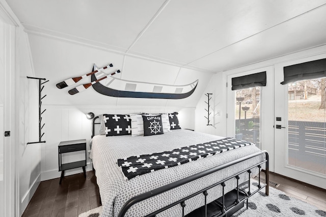 bedroom featuring access to exterior, hardwood / wood-style flooring, and french doors