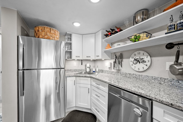 kitchen with open shelves, a sink, white cabinetry, and stainless steel appliances