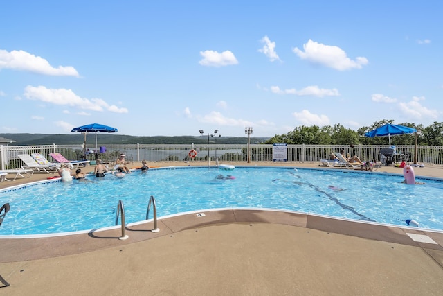 pool featuring a patio area and fence