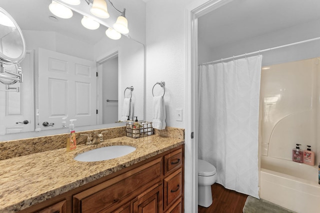 bathroom featuring toilet, shower / tub combo with curtain, wood finished floors, vanity, and a notable chandelier