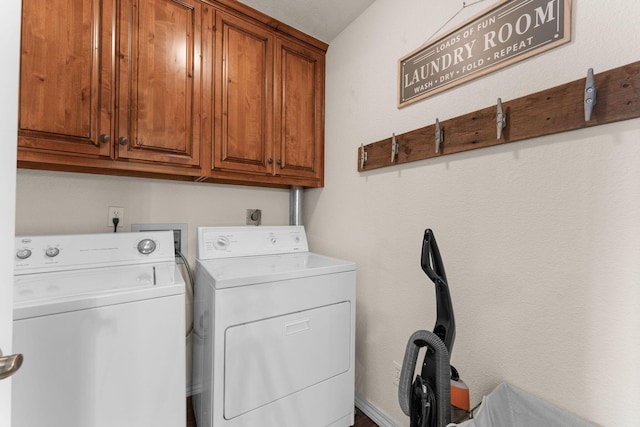 clothes washing area with cabinet space and washing machine and clothes dryer