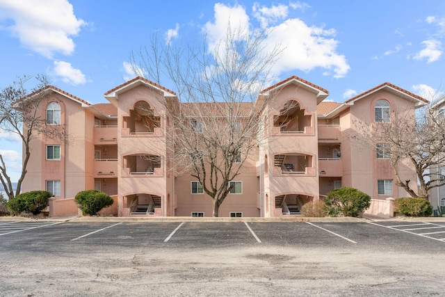 view of building exterior featuring uncovered parking